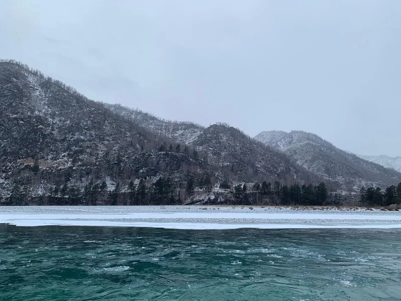 Snowy mountains above a turquoise river