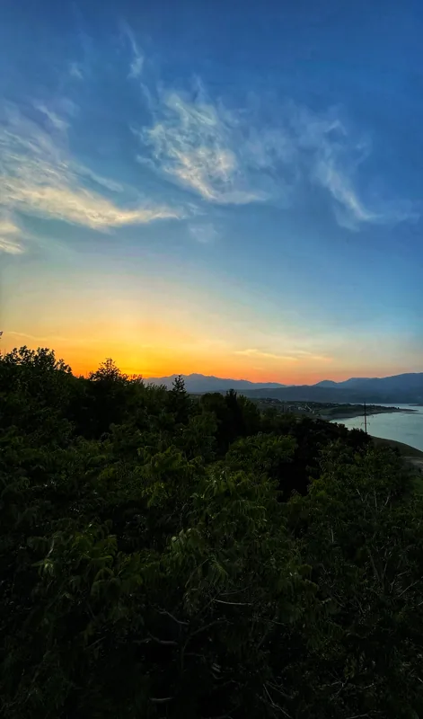 Evening sky over a lake and forest