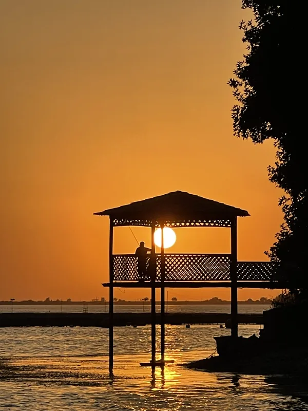 Waterside pavilion in orange evening light