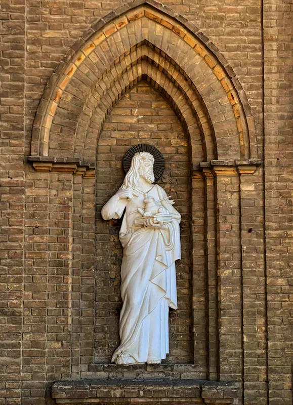 White statue in an arched niche