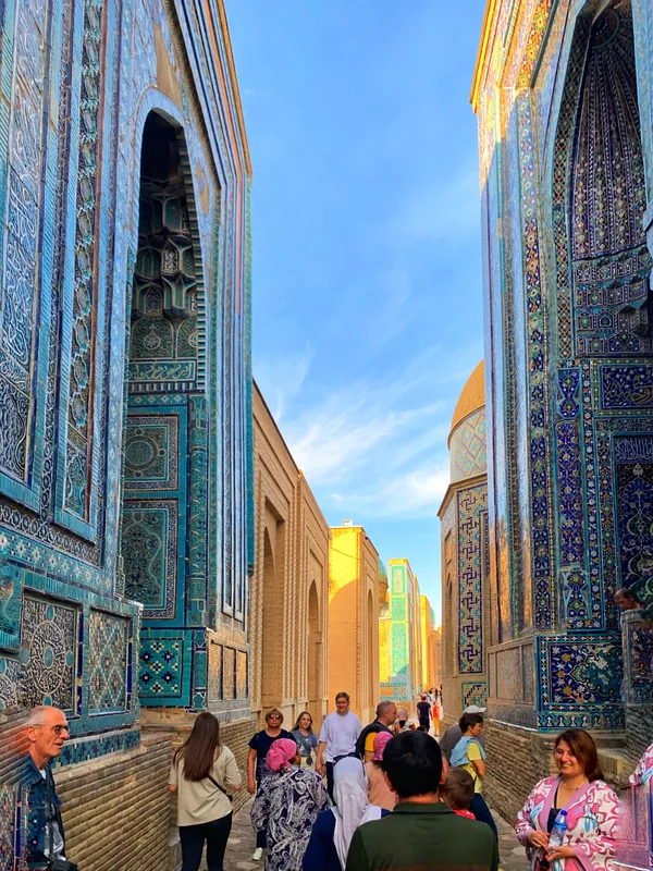 Passage between tall mosaic facades