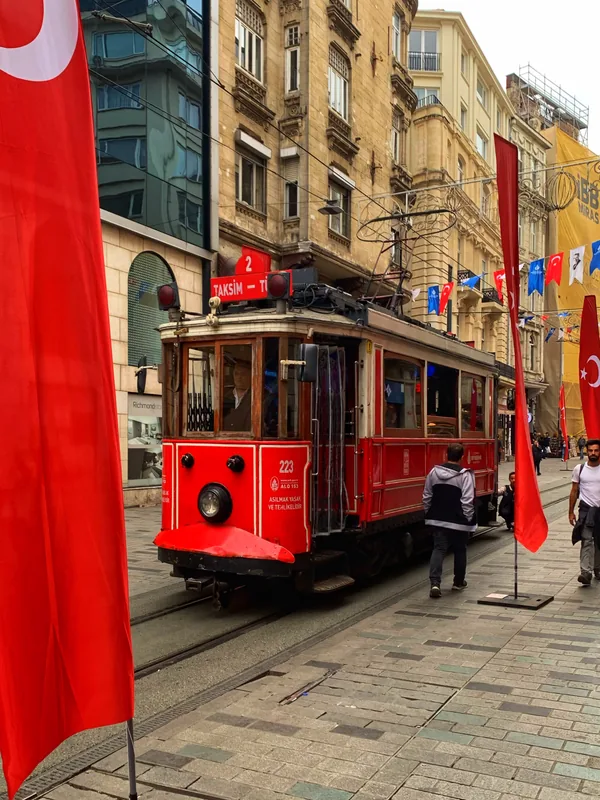 Red tram on a city street