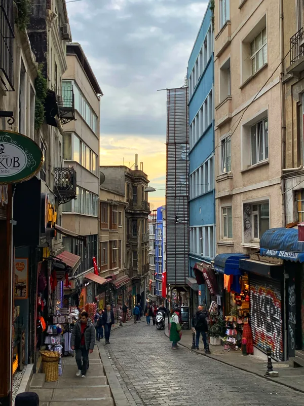 Steep city street with a view of a tower